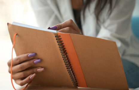 lady adding an entry in her diary